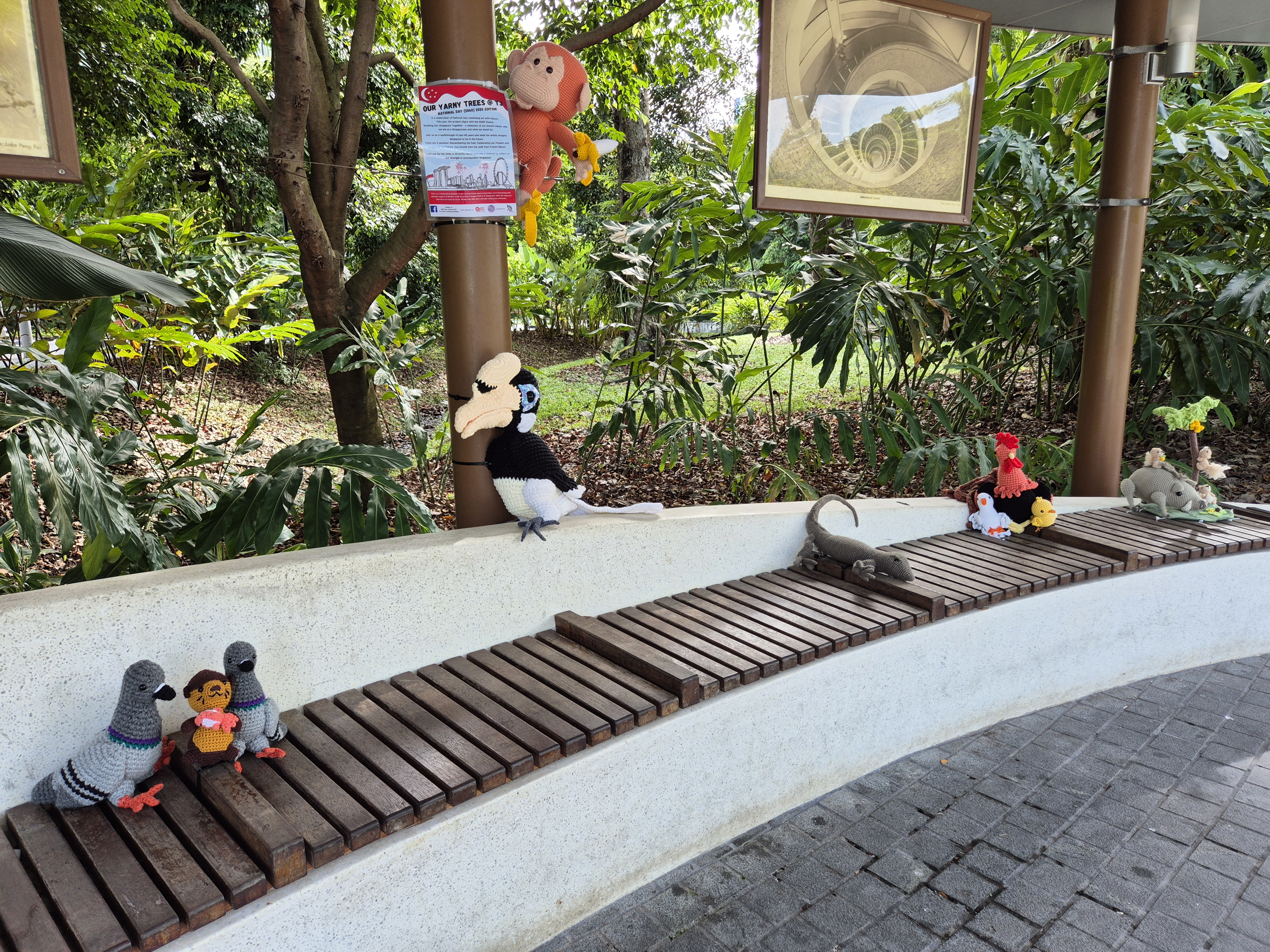 Crocheted animals on the bench represent distinct species that each play a vital role in our ecosystem, much like Singapore.